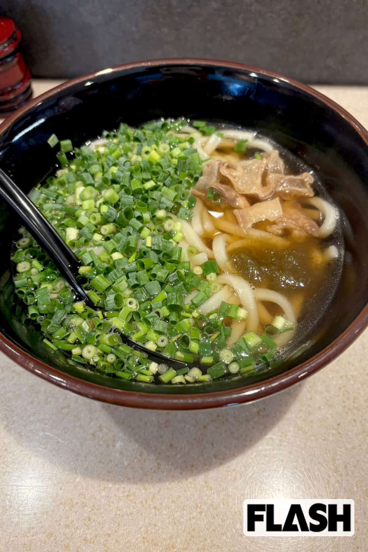 「浪花かすうどん むねひろ　田町店」（東京・三田）の「ネギうどん」。「今回は『冷やし』特集だとはわかってるけど、ここではいつも温かいのを頼んでしまうなあ……。『ネギうどん』は油かすがしっかり入っているのに、グッと上品な味になって、さっぱりしてて夏向きやと思います」（山下）