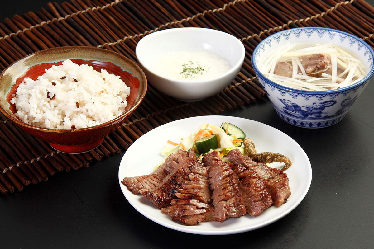 【たんや善治郎】JR仙台駅3F牛たん通り・営業時間／10:00～21:30（L.O. 21:00）年中無休。平日でも1時間以上の行列ができる人気店。牛たんの「選別・切り込み・塩ふり・漬け込み・熟成」を職人が手作業でおこない、炭火で焼き上げるスタイルで提供。1本の牛たんからわずか1、2枚しか取れない希少部位を厚切りで提供する「上撰極厚真中たん定食（3枚9切れ）」が人気だ。