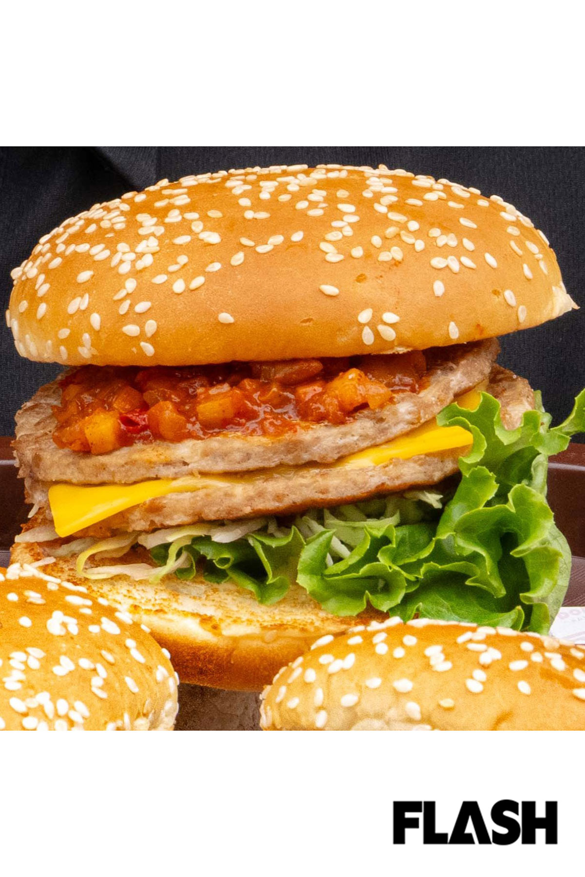【ケバブバーガー／2026年5月発売 ￥690（税込）期間限定販売】パティ2枚に具だくさんのトマトソースとシャキシャキのキャベツ、濃厚チーズを合わせた一品。ケバブ風のスパイスがほんのり香る “屋台めし” 風の豪快な見た目だが、野菜のさわやかさがあり、「最後まで飽きずに美味しく食べられる」と女性にも人気（写真・福田ヨシツグ）